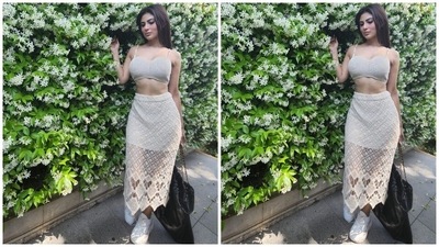 Mouni's fit in the photos features a bralette in an off-white shade. It comes with crocheted knit details, barely-there straps, a sweetheart neckline and cropped hem length flaunting her toned midriff. A midi-length bodycon skirt with a cut-out knit overlay rounded off the ensemble. (Instagram/@imouniroy) Mouni's fit in the photos features a bralette in an off-white shade. It comes with crocheted knit details, barely-there straps, a sweetheart neckline and cropped hem length flaunting her toned midriff. A midi-length bodycon skirt with a cut-out knit overlay rounded off the ensemble. (Instagram/@imouniroy)
