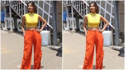 Shilpa styled the Y2K-inspired outfit with pointed stilettos, chunky bracelets, a metallic watch, several rings and a chain-linked contrast green necklace with a floral-shaped pendant. (HT Photo/Varinder Chawla) Shilpa styled the Y2K-inspired outfit with pointed stilettos, chunky bracelets, a metallic watch, several rings and a chain-linked contrast green necklace with a floral-shaped pendant. (HT Photo/Varinder Chawla)