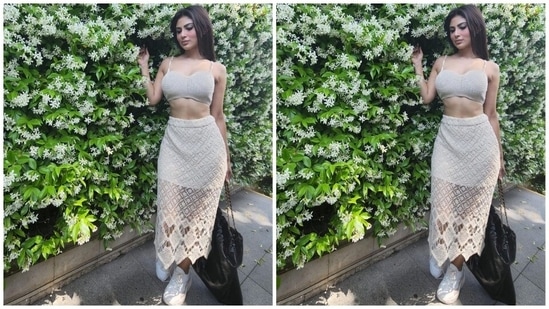 Mouni's fit in the photos features a bralette in an off-white shade. It comes with crocheted knit details, barely-there straps, a sweetheart neckline and cropped hem length flaunting her toned midriff. A midi-length bodycon skirt with a cut-out knit overlay rounded off the ensemble.(Instagram/@imouniroy)