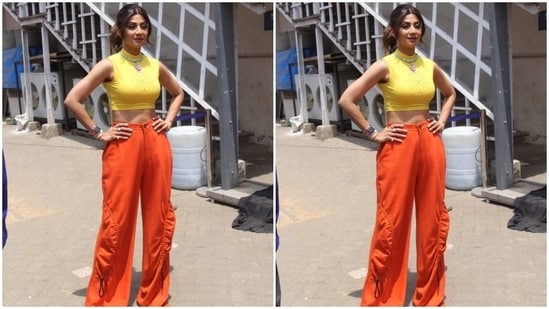 Shilpa Shetty posed for the paparazzi outside the shooting venue before joining Nushrratt. The fitness enthusiast and mother-of-two donned a chic ensemble in bright yellow and orange shades for the occasion.(HT Photo/Varinder Chawla)