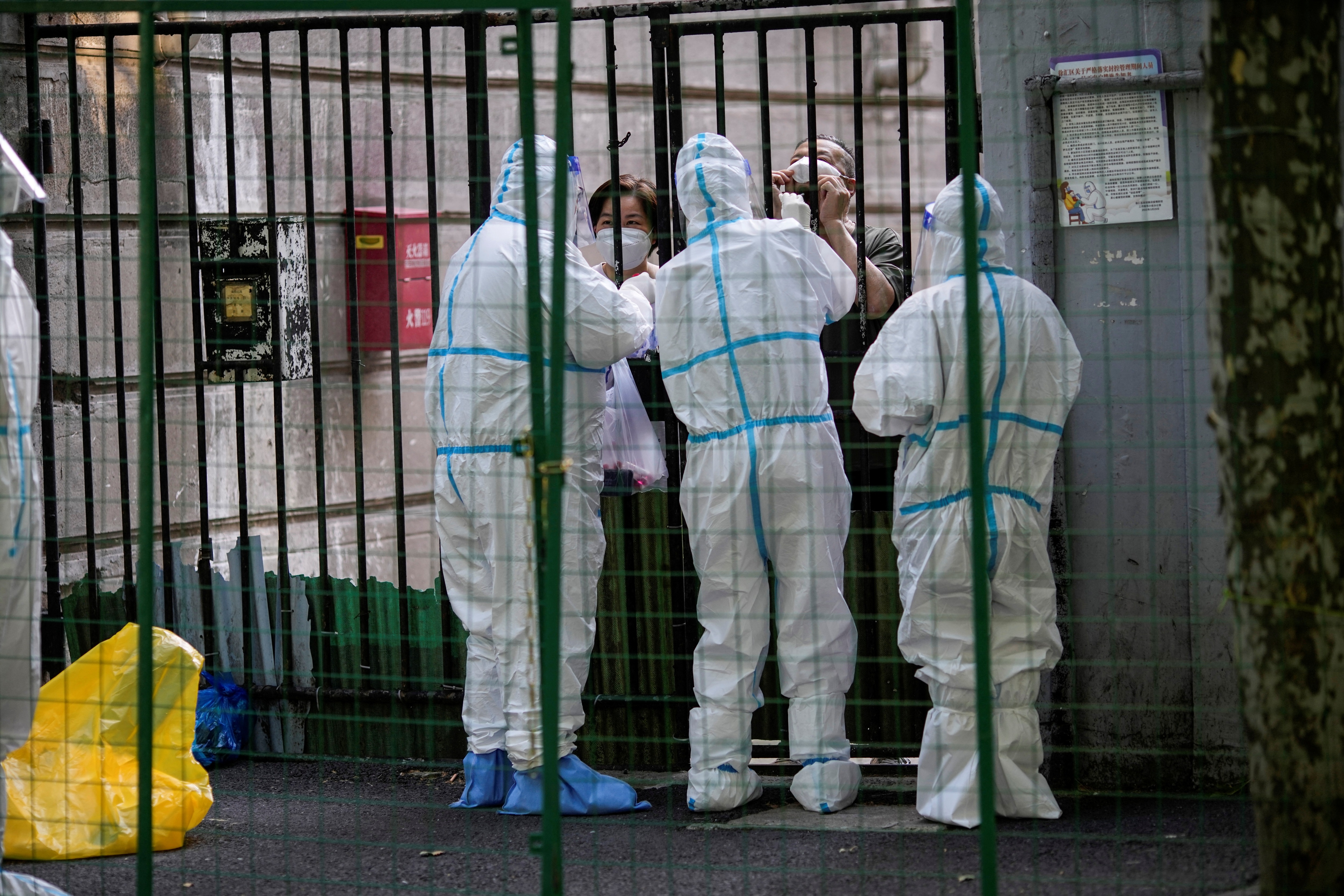 A resident gets tested for the coronavirus disease behind barriers of a sealed area on Wednesday, after the lockdown placed to curb the outbreak was lifted in Shanghai, (REUTERS)