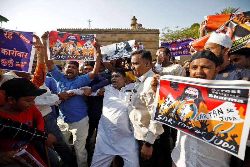 People shout slogans as they hold placards during a protest demanding the arrest of Nupur Sharma for her comments on Prophet Mohammed, in Ahmedabad, on June 8, 2022.&nbsp; (REUTERS)