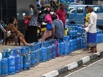 People queue to buy Liquefied Petroleum Gas (LPG) cylinders following shortages of essentials across Sri Lanka, in Colombo on Friday. People queue to buy Liquefied Petroleum Gas (LPG) cylinders following shortages of essentials across Sri Lanka, in Colombo on Friday.