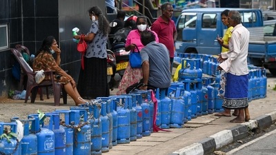 People queue to buy Liquefied Petroleum Gas (LPG) cylinders following shortages of essentials across Sri Lanka, in Colombo on Friday. (AFP)