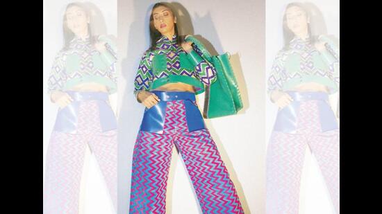 This outfit has been made from a discarded sari, fused with khadi to make it thicker. The bag has been made from recycled rubber. (Shivamm Pathak)