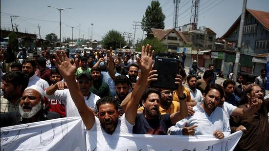 Muslims shout slogans as they hold placards during a protest demanding the arrest of Bharatiya Janata Party (BJP) member Nupur Sharma for her comments on Prophet Mohammed, in Srinagar on Friday. The protests and shutdown in Kashmir were spontaneous as no group had called for any strike or protests. (Reuters)