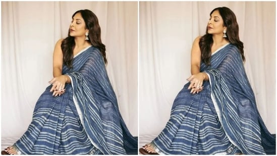 Shefali's cotton saree came with silver borders.  She paired it with a sleeveless blue blouse while posing for a photoshoot. (Instagram / @shefalishahofficial)