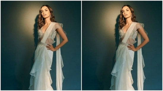 Manushi layered her look with a white embellished blouse and accessorised her saree with a white belt at the waist, decorated in silver embellishments.(Instagram/@manushi_chhillar)