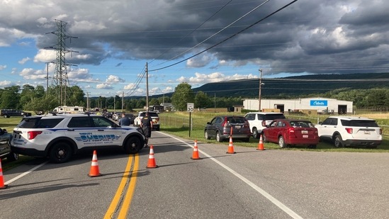 Law enforcement vehicles block the road at the scene of a shooting at a Maryland business near Smithsburg, Md.(AP)