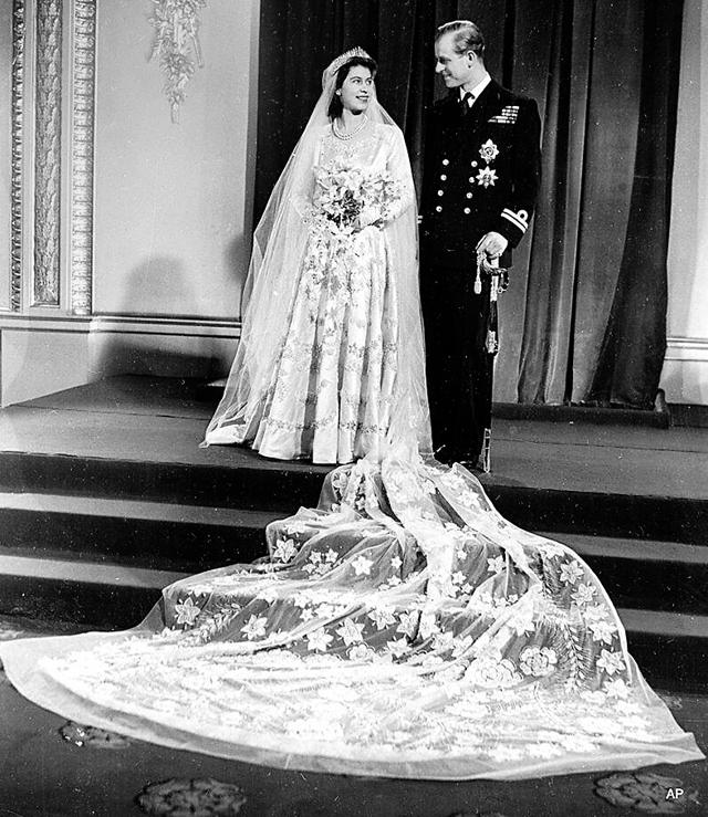 Created by British designer, Norman Hartnell, this iconic wedding gown was made of duchesse satin, ivory silk and silver thread embellished with pearls and crystals featuring a dramatic train. (Photo: AFP, Facebook, Instagram and Twitter) Created by British designer, Norman Hartnell, this iconic wedding gown was made of duchesse satin, ivory silk and silver thread embellished with pearls and crystals featuring a dramatic train. (Photo: AFP, Facebook, Instagram and Twitter)