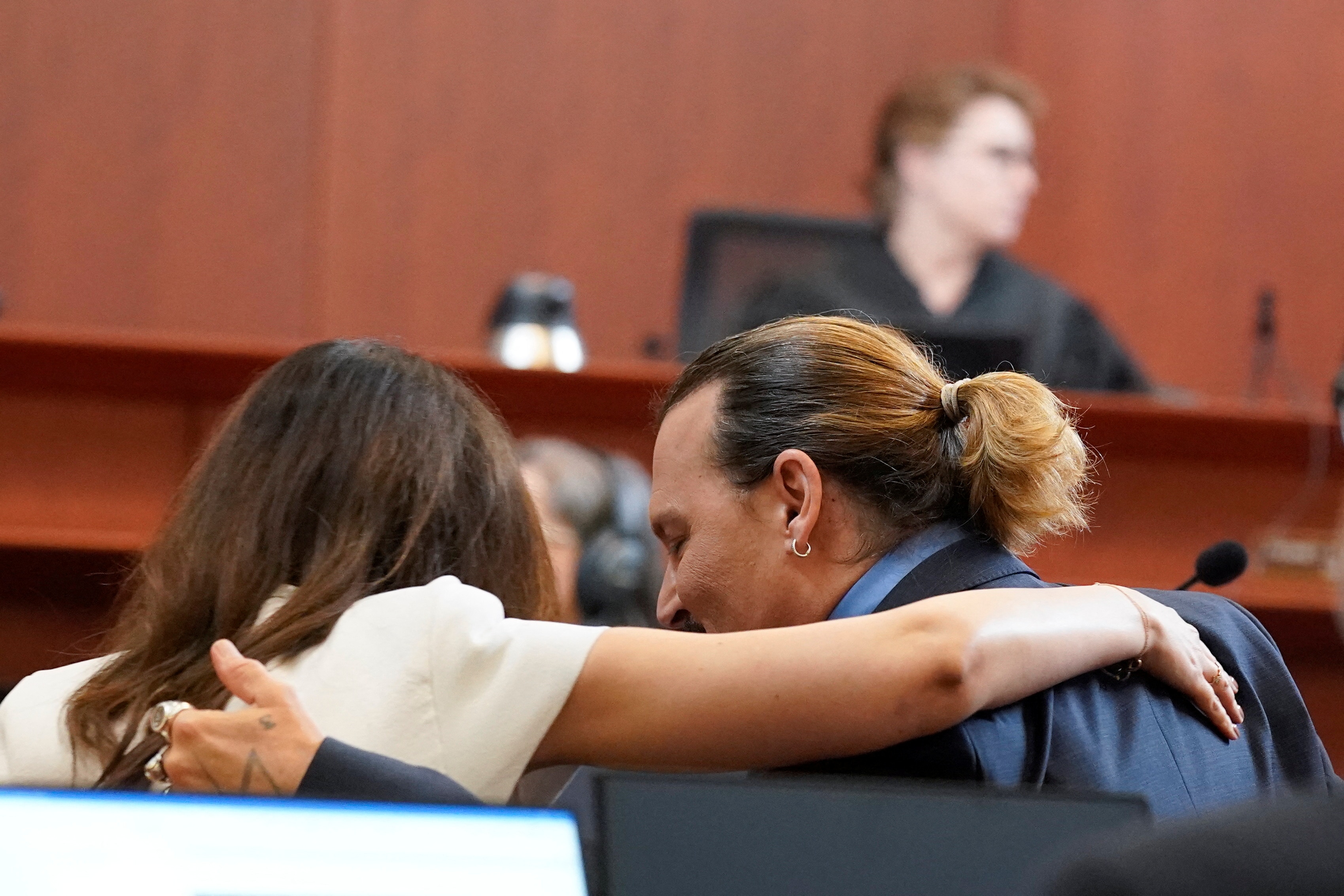 Johnny Depp speaks to Camille Vasquez during his defamation case against ex-wife Amber Heard, in the courtroom at the Fairfax County Circuit Courthouse in Fairfax, Virginia, U.S., May 27, 2022. Steve Helber/Pool via REUTERS(REUTERS)