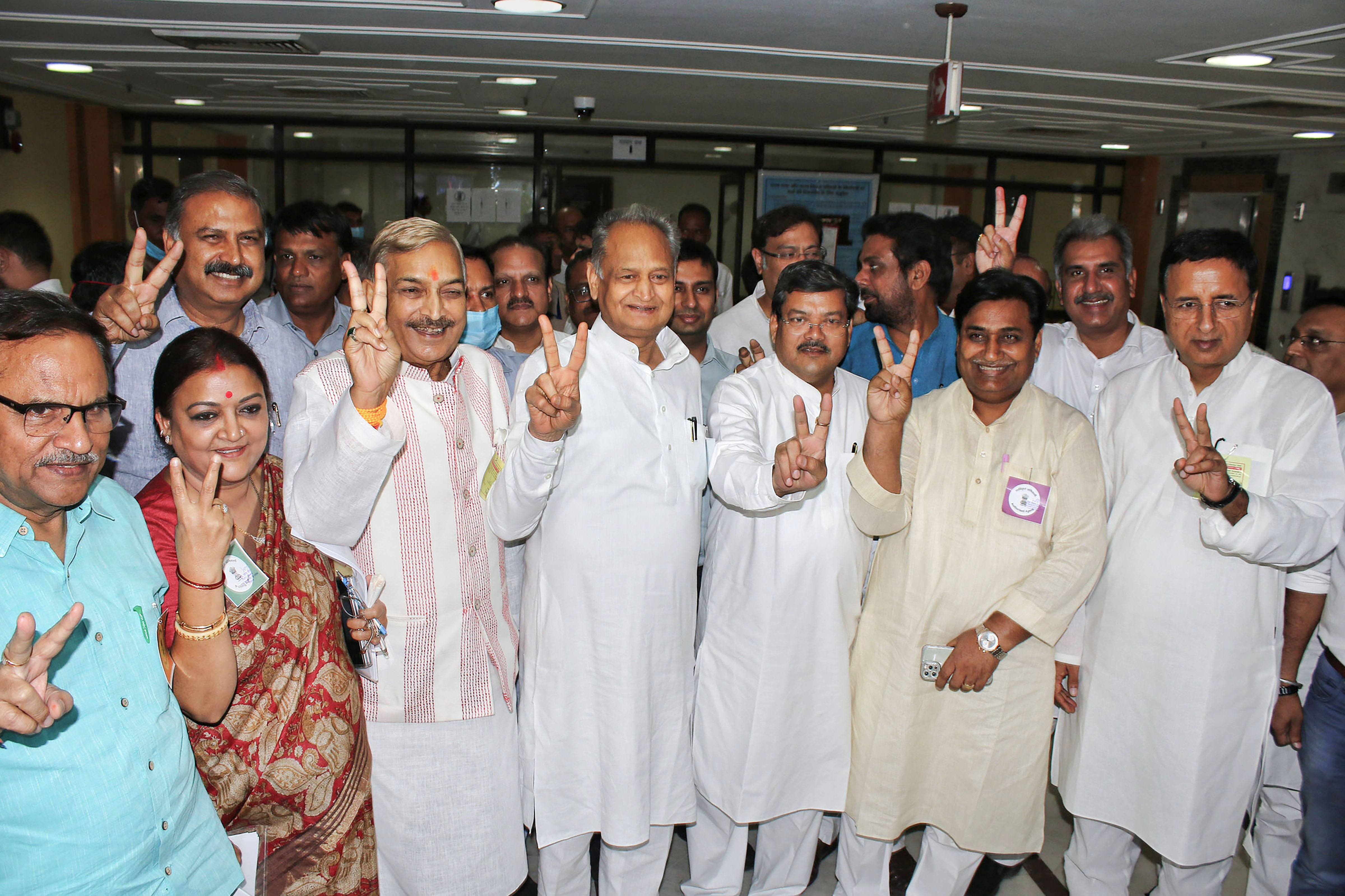 Rajasthan Chief Minister Ashok Gehlot with the Congress candidates and others flashes the victory sign during the Rajya Sabha election in Jaipur, on Friday. (PTI) Rajasthan Chief Minister Ashok Gehlot with the Congress candidates and others flashes the victory sign during the Rajya Sabha election in Jaipur, on Friday. (PTI)
