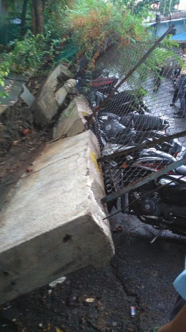 A boundary wall collapsed on Karve road and damaged ten two-wheelers. (HT PHOTO)