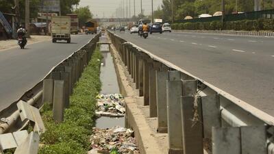 view of a drain constructed to prevent waterlogging is filled with garbage, along NH-48 in Gurugram. (Vipin Kumar/HT Photo)