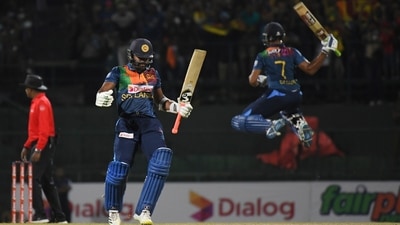 Sri Lanka's Dasun Shanaka, right, and Chamika Karunaratne celebrate their team's victory over Australia in the third Twenty20 cricket match in Pallekele, Sri Lanka, Saturday, June 11, 2022. (AP)