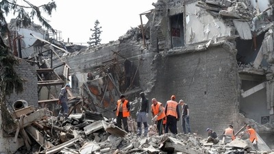 Emergency management specialists and volunteers remove the debris of a theatre building destroyed in the course of Ukraine-Russia conflict in the southern port city of Mariupol. (REUTERS)