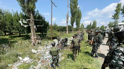 Security personnel deployed at Srinagar-Baramulla national highway after a suspected improvised explosive device was found along the roadside, at Putkha area of Sopore, in Baramulla on Saturday. (ANI Photo)