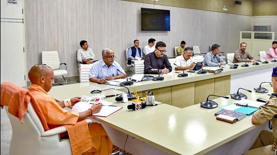 Uttar Pradesh chief minister Yogi Adityanath holding a meeting to review the law and order situation. (PTI PHOTO)