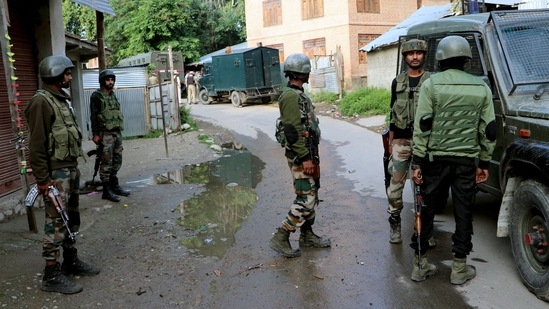 Security personnel stand guard where an encounter between militants and security forces took place, at Khandipora, in Kulgam on Saturday.(ANI) Security personnel stand guard where an encounter between militants and security forces took place, at Khandipora, in Kulgam on Saturday.(ANI)