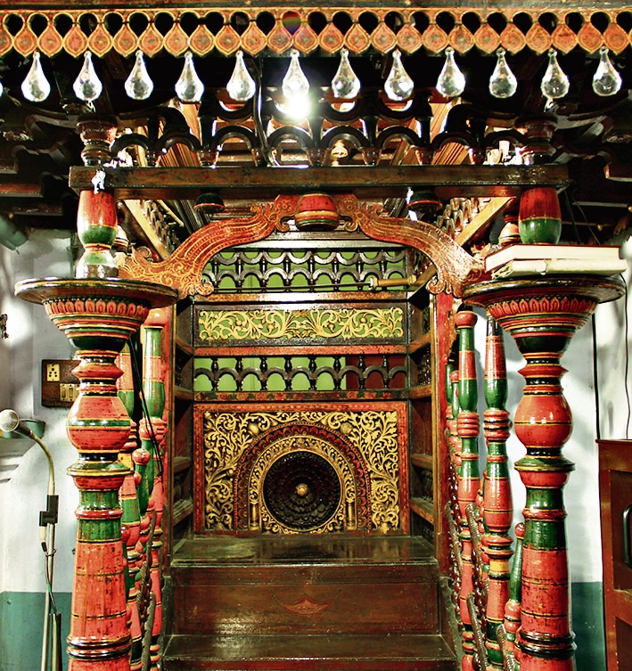 The original minbar or pulpit still stands within the mosque. The centuries-old teak platform bears intricately carved floral motifs covered in lacquer. (Photo courtesy Benny Kuriakose & Associates)