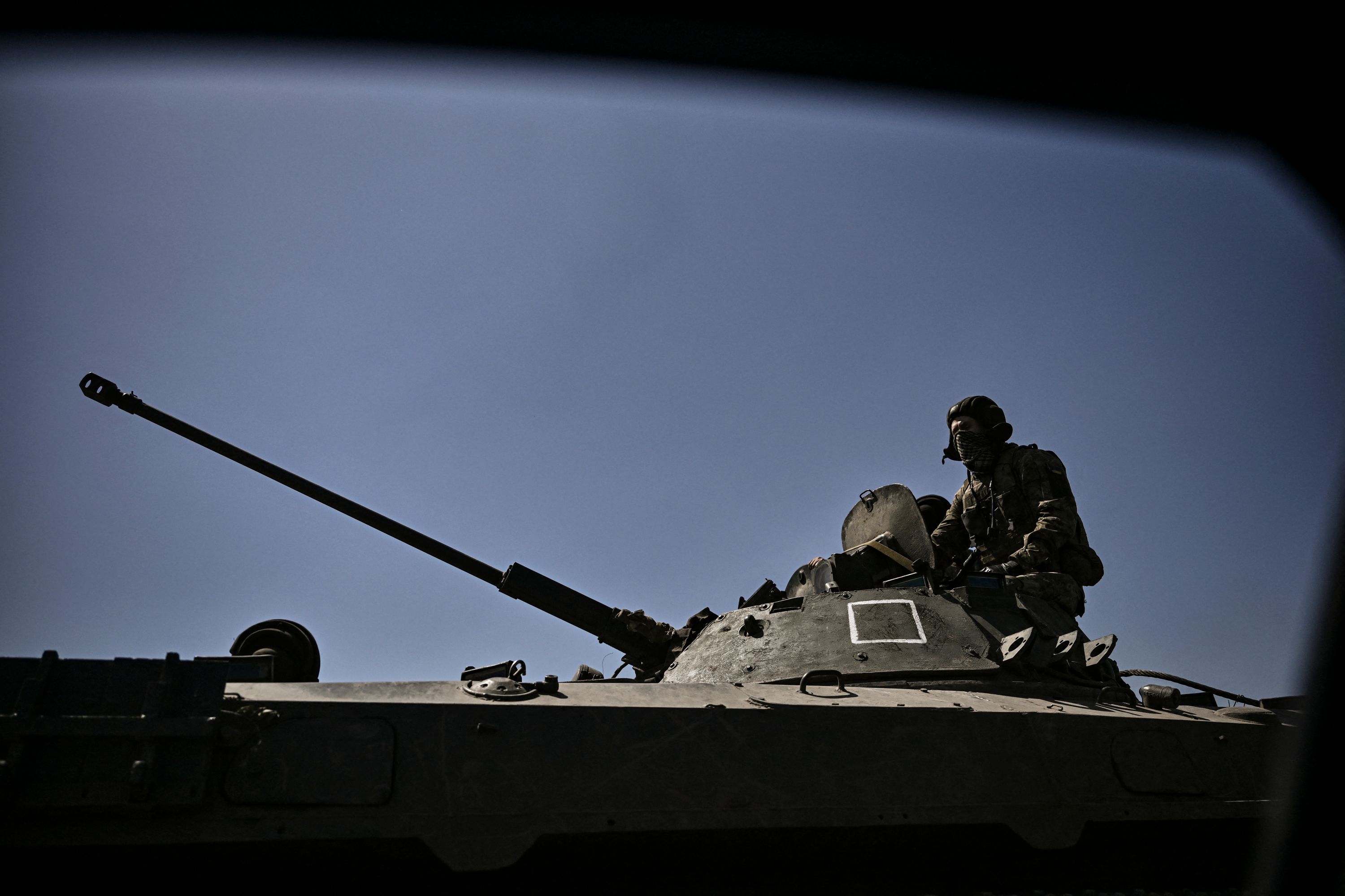 &nbsp;A member of the Ukrainian troops stands on an armoured vehicle moving towards the front line in the city of Lysychansk in the eastern Ukraine region of Donbas on June 9, 2022.&nbsp; (AFP)