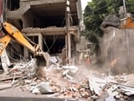 A bulldozer demolishes a building that the police claimed belonged to a close relative of the June 3 Kanpur violence main accused Zafar Hayat Hashmi, on Saturday. (ANI)