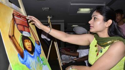 A participant lending final touches to her artwork aimed at raising awareness on child labour at the Ishmeet Academy, Ludhiana. (HT Photo)