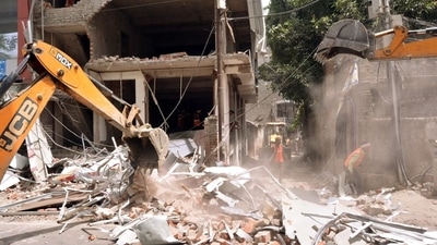 A bulldozer demolishes a building that the police claimed belonged to a close relative of the June 3 Kanpur violence main accused Zafar Hayat Hashmi, on Saturday. (ANI) A bulldozer demolishes a building that the police claimed belonged to a close relative of the June 3 Kanpur violence main accused Zafar Hayat Hashmi, on Saturday. (ANI)