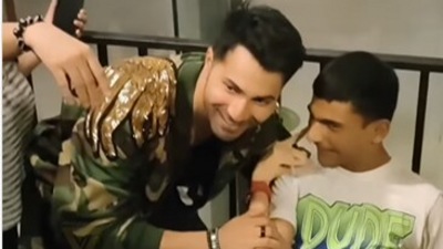 Varun Dhawan with a fan. Varun Dhawan with a fan.