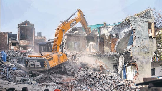 Bulldozer being used to demolish the 'illegally constructed' residence of Javed Ahmed in Prayagraj on Sunday. (PTI)