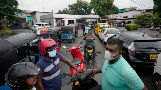 People wait in a long queues to buy fuel for their vehicles at a filling station in Colombo, Sri Lanka.(AP) People wait in a long queues to buy fuel for their vehicles at a filling station in Colombo, Sri Lanka.(AP)