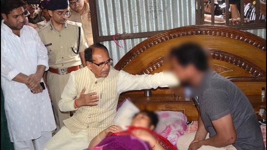 Madhya Pradesh chief minister Shivraj Singh Chouhan met the woman at her residence in Bhopal on Sunday after she fiercely fought her attackers on Friday night. (PTI)