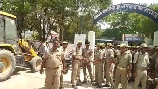 A police team and a bulldozer at the Kareli police station ready to move for the demolition drive.