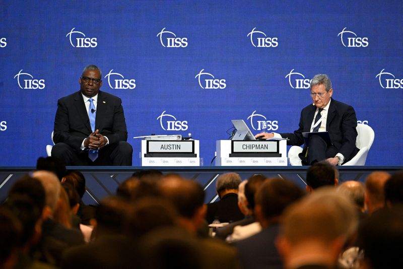 US defence secretary Lloyd Austin (left) and IISS director-general and chief executive Dr John Chipman speak at the First Plenary Session of the 19th Shangri-La Dialogue in Singapore. (REUTERS)