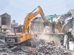 Bulldozer being used to demolish the 'illegally constructed' residence of Javed Ahmed in Prayagraj on Sunday. (PTI) Bulldozer being used to demolish the 'illegally constructed' residence of Javed Ahmed in Prayagraj on Sunday. (PTI)
