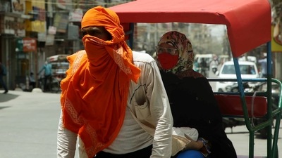 A rickshaw puller covers his face from the heatwave as temperature touches 44 degrees, in New Delhi. (ANI Photo)