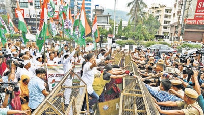 Police personnel try to stop Congress supporters, during a protest in Guwahati on Monday. (ANI) Police personnel try to stop Congress supporters, during a protest in Guwahati on Monday. (ANI)