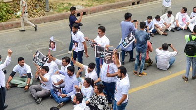 Congress activists stage a sit-in protest against summoning of party leader Rahul Gandhi in the National Herald case, outside AICC office in New Delhi (PTI)