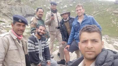 The rescue team with Israeli trekker Ron Yarn (in blue jacket) who lost his way while crossing Hamta Pass in Lahaul-Spiti district on Monday. (HT Photo)