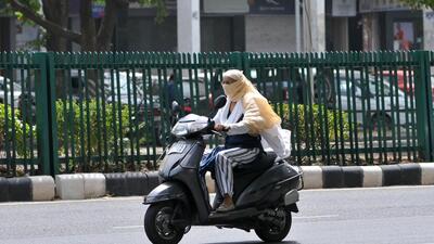 A commuter covers her face on a sweltering Monday afternoon in Chandigarh (Ravi Kumar/HT)