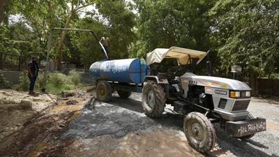A Municipal Corporation Gurugram (MCG) tanker fills water from a boosting station to supply in city areas in Gurugram. (Parveen Kumar/HT Photo)