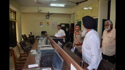 Court officials who had reached the DEO’s office to attach assets, on Monday. (Harvinder Singh/HT) Court officials who had reached the DEO’s office to attach assets, on Monday. (Harvinder Singh/HT)