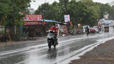 A motorist is seen riding in the rain in Dehu on Monday. (HT PHOTO)