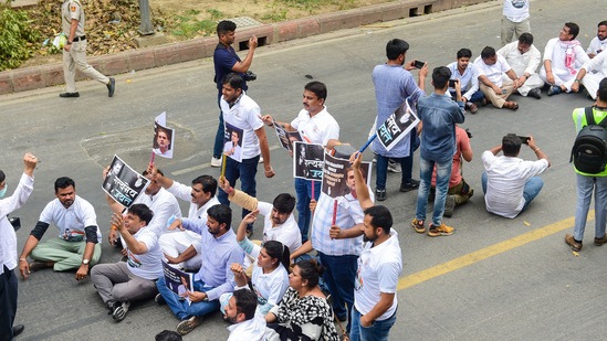 Congress activists stage a sit-in protest against summoning of party leader Rahul Gandhi in the National Herald case, outside AICC office in New Delhi(PTI)