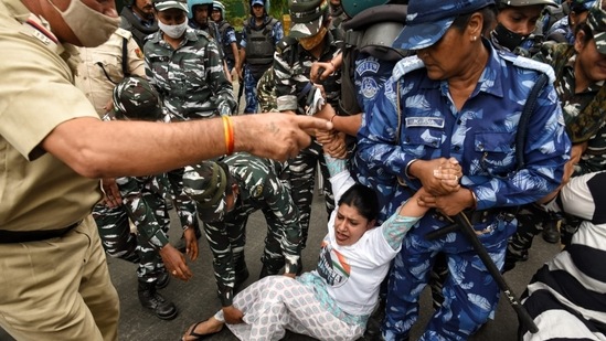 Security personnel holding protester as massive demonstrations take place.(Sanchit Khanna/Hindustan Times)