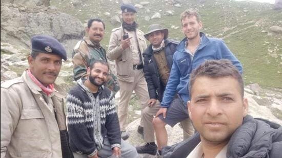 The rescue team with Israeli trekker Ron Yarn (in blue jacket) who lost his way while crossing Hamta Pass in Lahaul-Spiti district on Monday. (HT Photo)