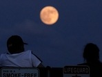 People watch the rising moon Monday, June 13, 2022, in East Boston, Mass. (Representational image) People watch the rising moon Monday, June 13, 2022, in East Boston, Mass. (Representational image)