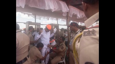 Police personnel are seen checking attendees at the pandal where the prime minister addressed a gathering, after inaugurating the a temple on Tuesday. (Pratham Gokhale/HT Photo)