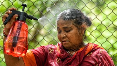 A woman cools off on a hot summer day in New Delhi. (ANI Photo)