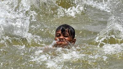 A boy swims to beat the heat on a hot summer afternoon as mercury levels soar in India. (ANI Photo) A boy swims to beat the heat on a hot summer afternoon as mercury levels soar in India. (ANI Photo)